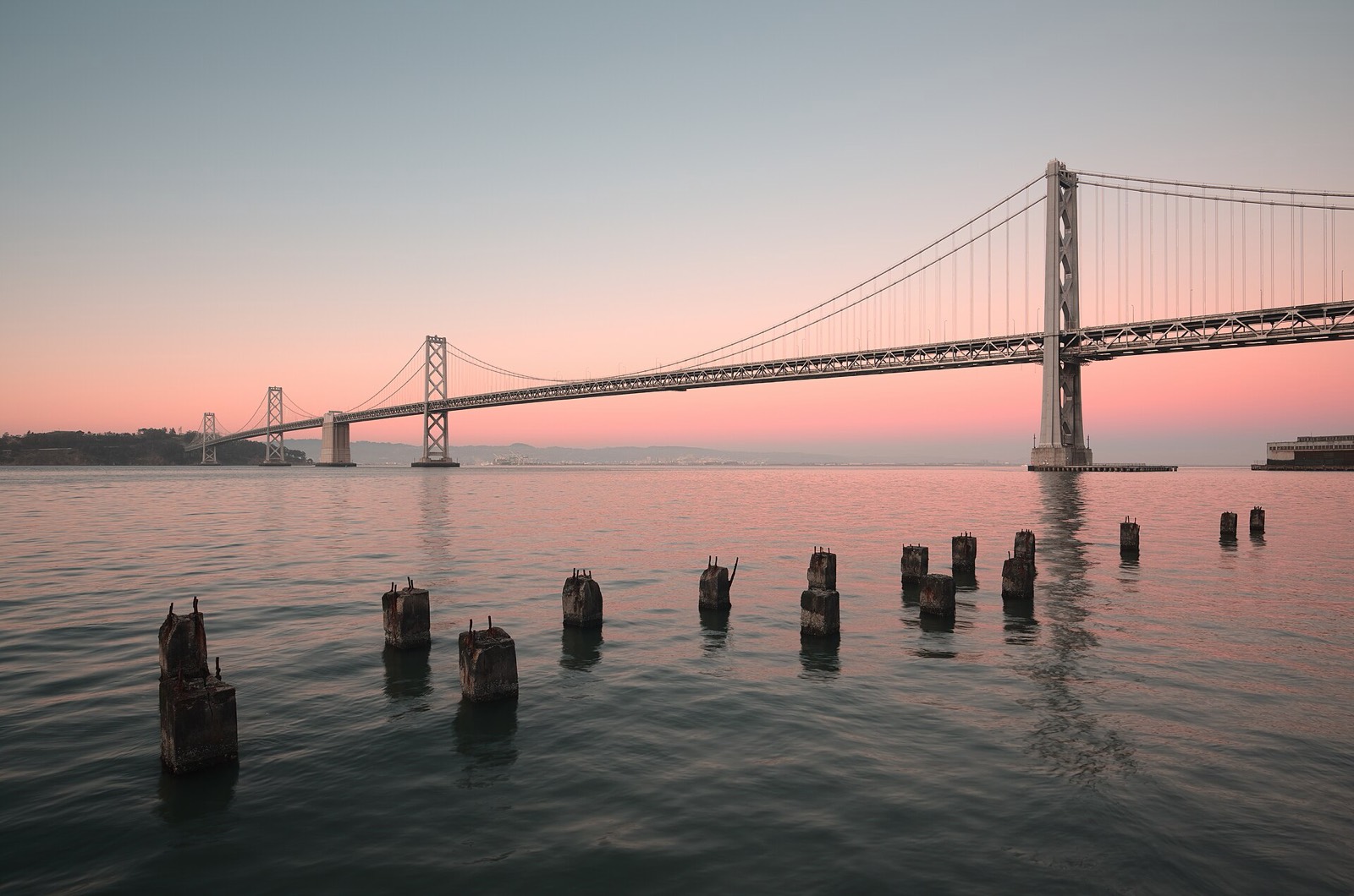 The Bay Bridge over the water at dusk