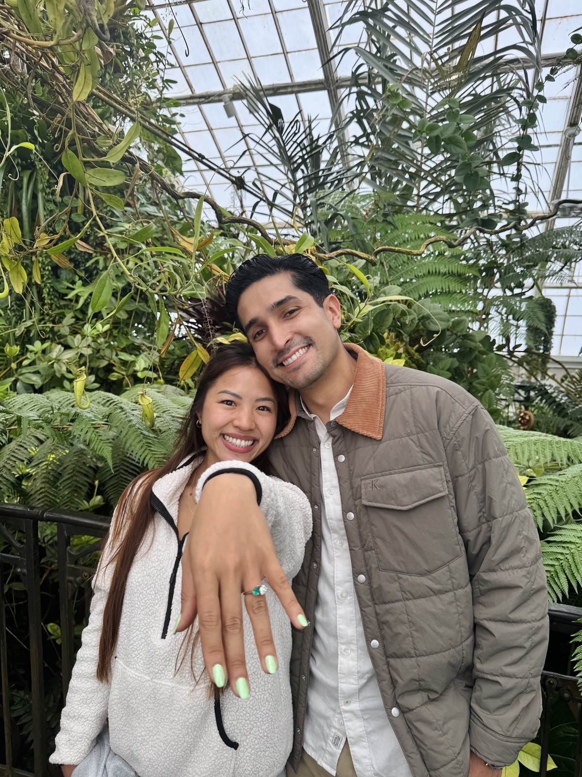 Trinique showing her ring, cheek to cheek with Juan Pablo in the conservatory